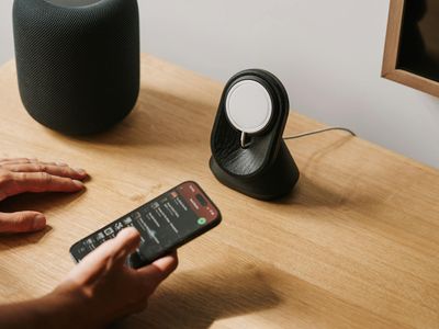 Person resting hands on a wooden table in peace